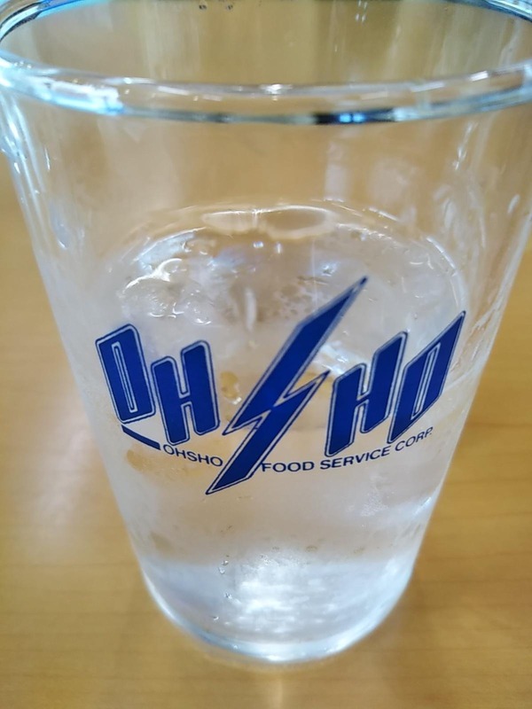 A glass of water with the company's logo